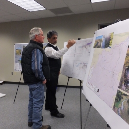 Two people reviewing project maps